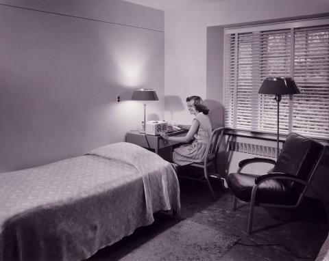 A Photo of a Female Student Relaxing in Drayer Hall, c. 1950